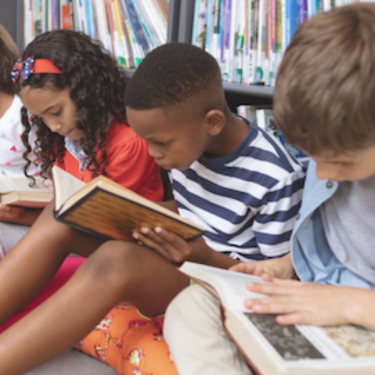  Group of children sitting on the floor reading books